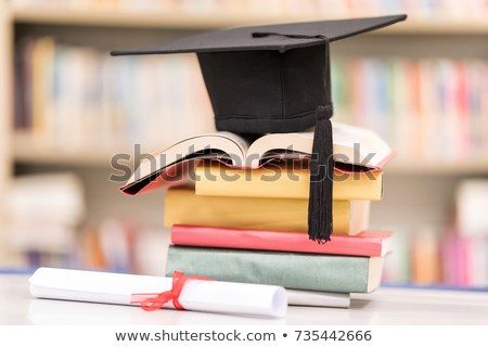 certificate-hat-on-stack-book-450w-735442666.jpg